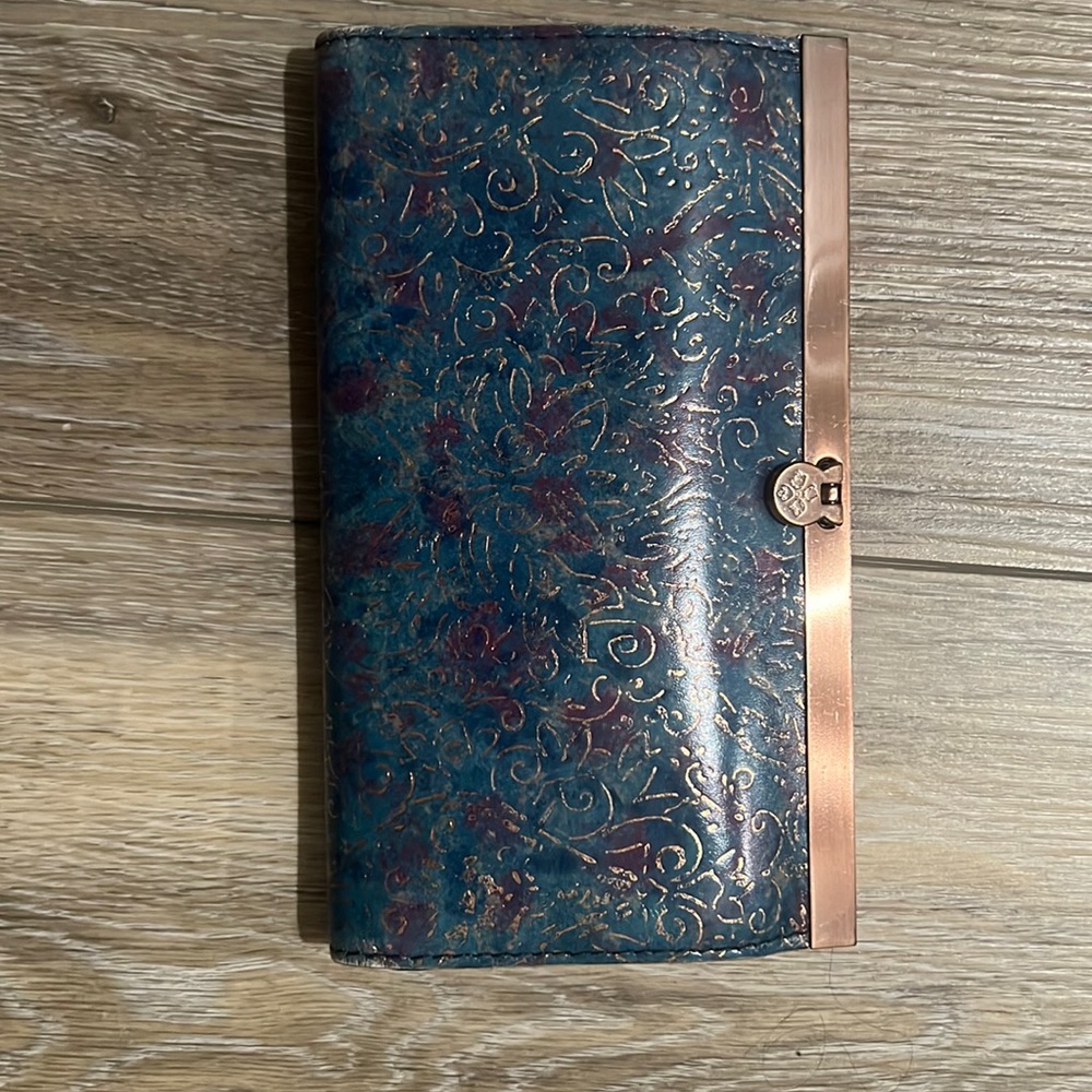 Patricia Nash wallet in blue gold and purple decorative pattern.